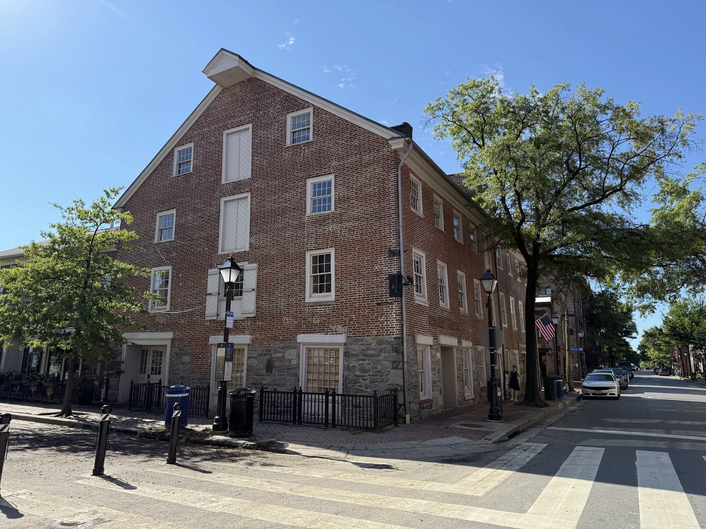 Cana Café’s future stone storefront at street level, with the sidewalk and crosswalk at King and South Union Streets